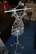 A wrought iron display stand 50 1/2" high.