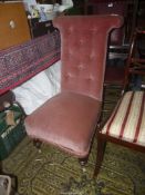 A circa 1900 high back Chair upholstered in dusky pink velvet type fabric and standing on turned