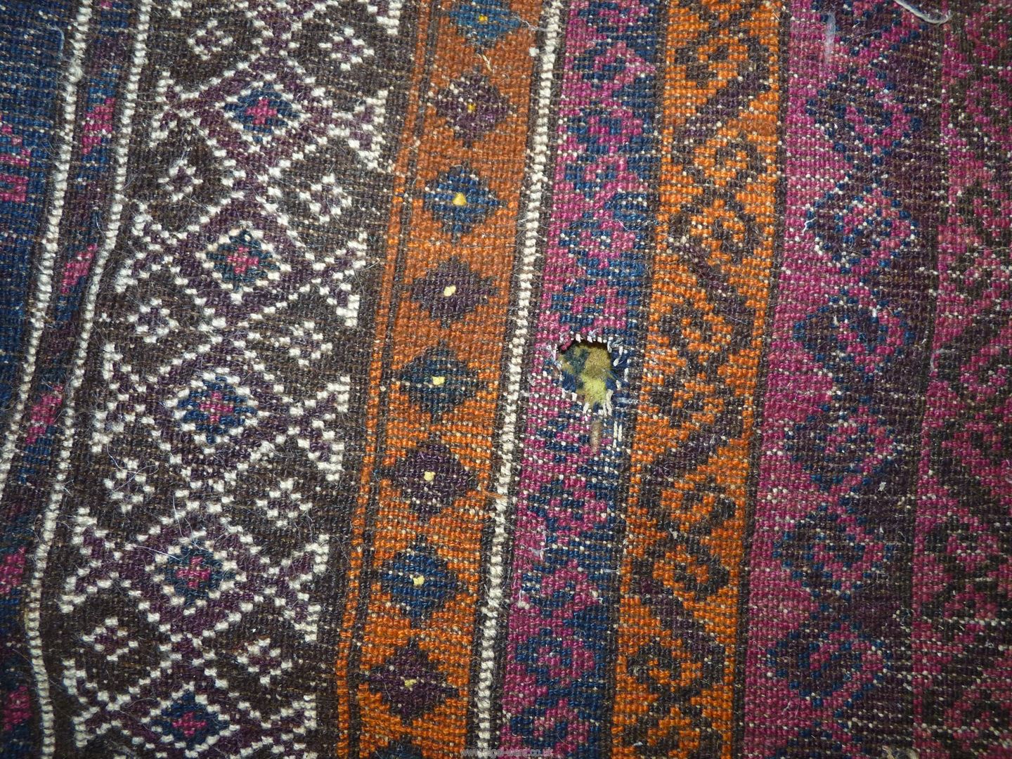 A Prayer rug in earth tones, brown and navy, 60'' x 35'' including fringe, some holes. - Image 4 of 4