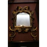 An old wall mirror with Gesso frame of scrolls and foliage, 21 1/4" x 12 1/2".