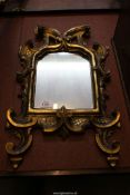 An old wall mirror with Gesso frame of scrolls and foliage, 21 1/4" x 12 1/2".