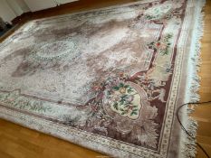 An extremely large Chinese mauve ground floral pattern bordered, patterned and fringed Carpet,