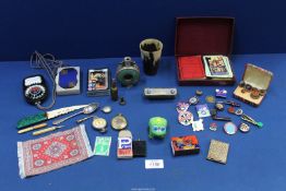 A quantity of miscellanea including a horn beaker, playing cards, compass, matchbox, lighters, etc.