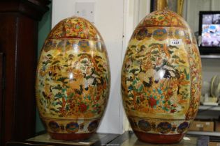 A pair of large Chinese Chinoiserie decorated ceramic Eggs decorated with birds and flora