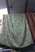 A large pair of green brocade interlined curtains having red and green tassel edging (some