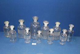 A quantity of clear glass Chemist's bottles,