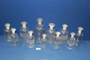A quantity of clear glass Chemist's bottles,