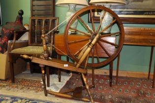 A Spinning Wheel, 26'' diameter, having detachable legs and a treadle.