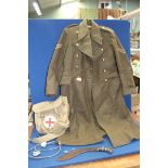 A 1951 pattern Military great Overcoat by Prices Taylors Ltd 1953 and a Military First Aid canvas