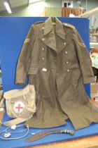 A 1951 pattern Military great Overcoat by Prices Taylors Ltd 1953 and a Military First Aid canvas