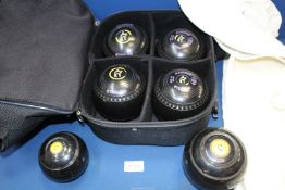 A set of four Almark Sterling Lawn bowls in holdall and with hat and jerkin and two other