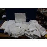 A quantity of linen including five linen sheets, two being embroidered, white embroidered bedspread,