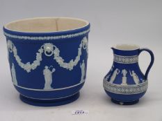 A large 19th century Wedgwood dark blue Jasperware Planter having classical scenes and swag