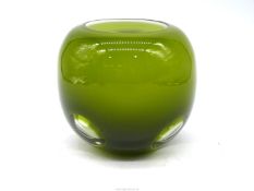 A heavy olive green Glass vase having four clear round windows with thick inner white lining and
