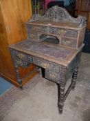 An unusual 20th century carved Oak writing Desk of small dimensions having an upstand with four