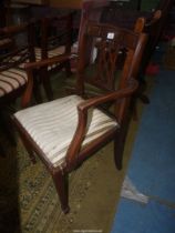 A Mahogany framed open armed Elbow Chair with a striped upholstered drop-in seat and a lattice