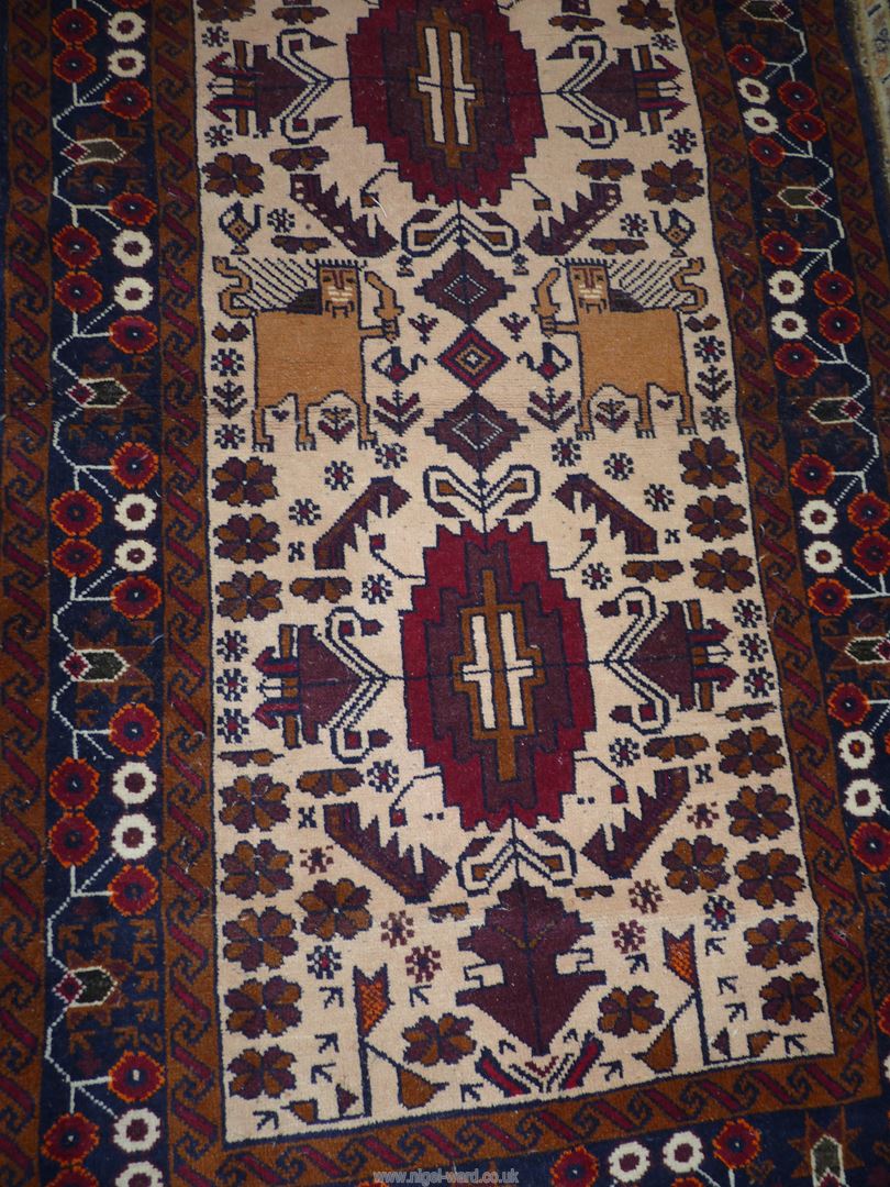 An Afghan Beluch rug in beige, blue and red shades, 69'' x 31 1/2'' including fringe. - Image 2 of 3