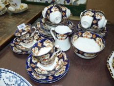 A Royal Albert part tea service in blue, orange, white and gilt to include; twelve cups,