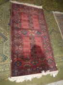 A Louis de Poortere Massoni carpet in earthy tones having a border pattern of small guls and two