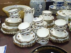 A large Delphine china tea service, octagonal shaped with raised swags of fruit,