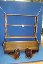 An Oak bookshelf/rack, pair of oak bookends and set of Oak hanging collapsible wall shelves.