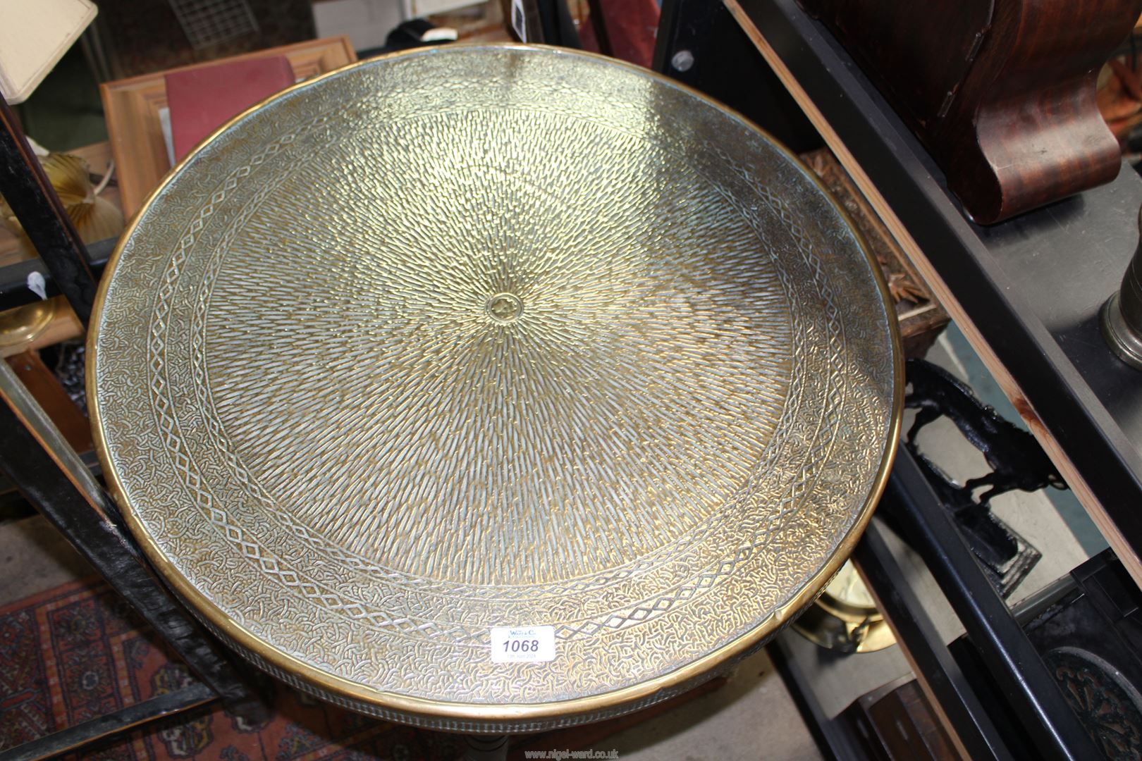 An early 20th century Benares brass top table with hammered design, on folding wooden base, - Image 2 of 3