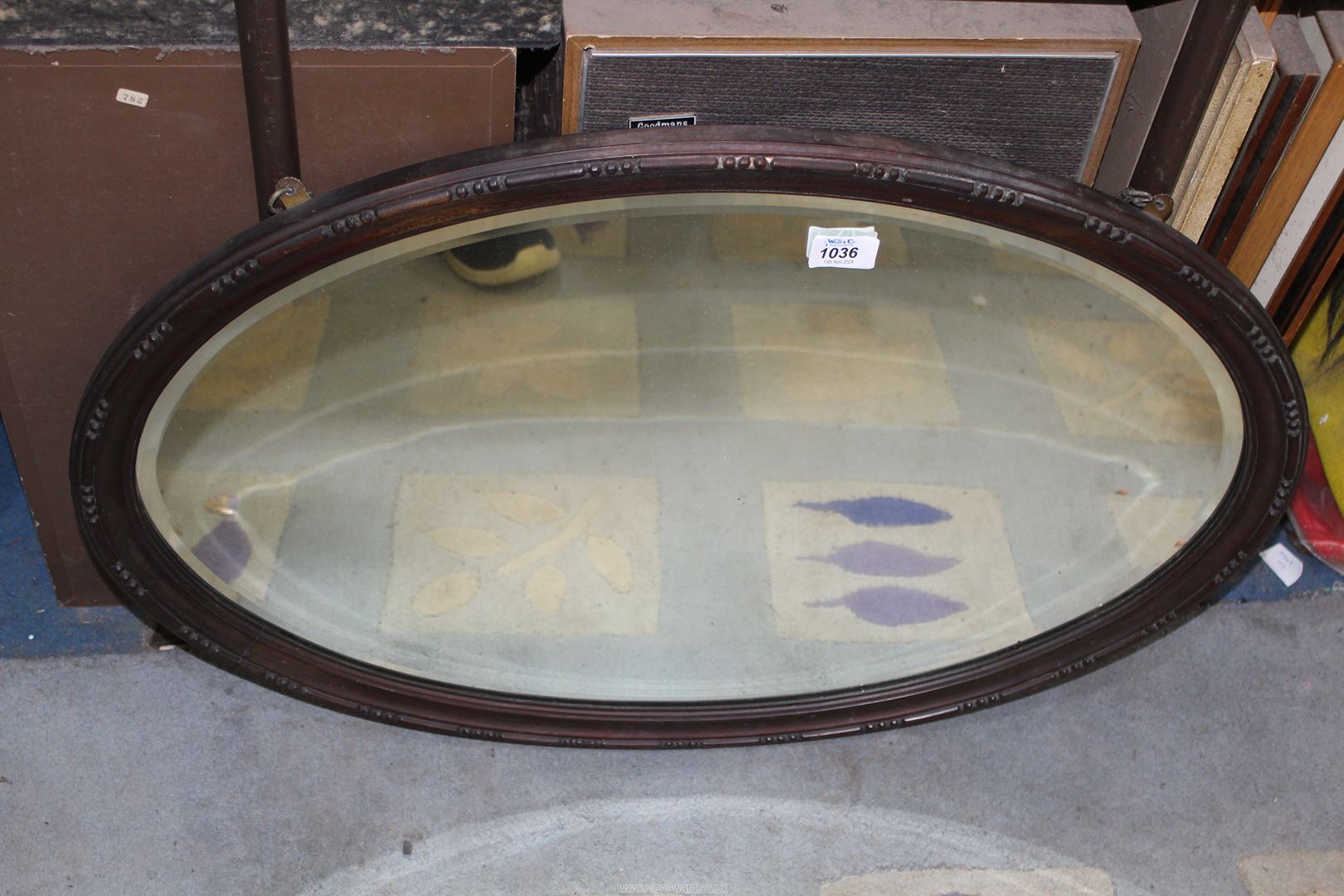 A Mahogany oval framed mirror, 30" x 20".