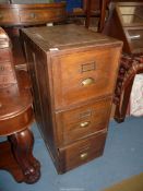 An old Oak three drawer Filing Cabinet with brass hood handles,