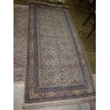 A border pattern and fringe rug in mixed colours of blue, pink, beige,