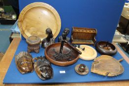 A quantity of treen including Tribal figures, bowls,platters, pipe rack stand , cup and saucer etc.