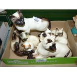 A quantity of Siamese cat ornaments including Royal Doulton, Beswick etc.