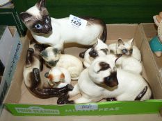 A quantity of Siamese cat ornaments including Royal Doulton, Beswick etc.