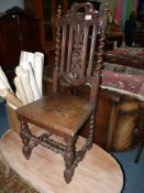 An Oak solid seated Hall Chair having turned legs united by twist stretchers,