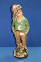 A large slipware figure of a Young boy in breeches, marked OP 260 on reverse, 24 1/2" tall.