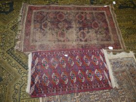 A small rug with Elephant footprint pattern in red and cream together with a Prayer rug (badly
