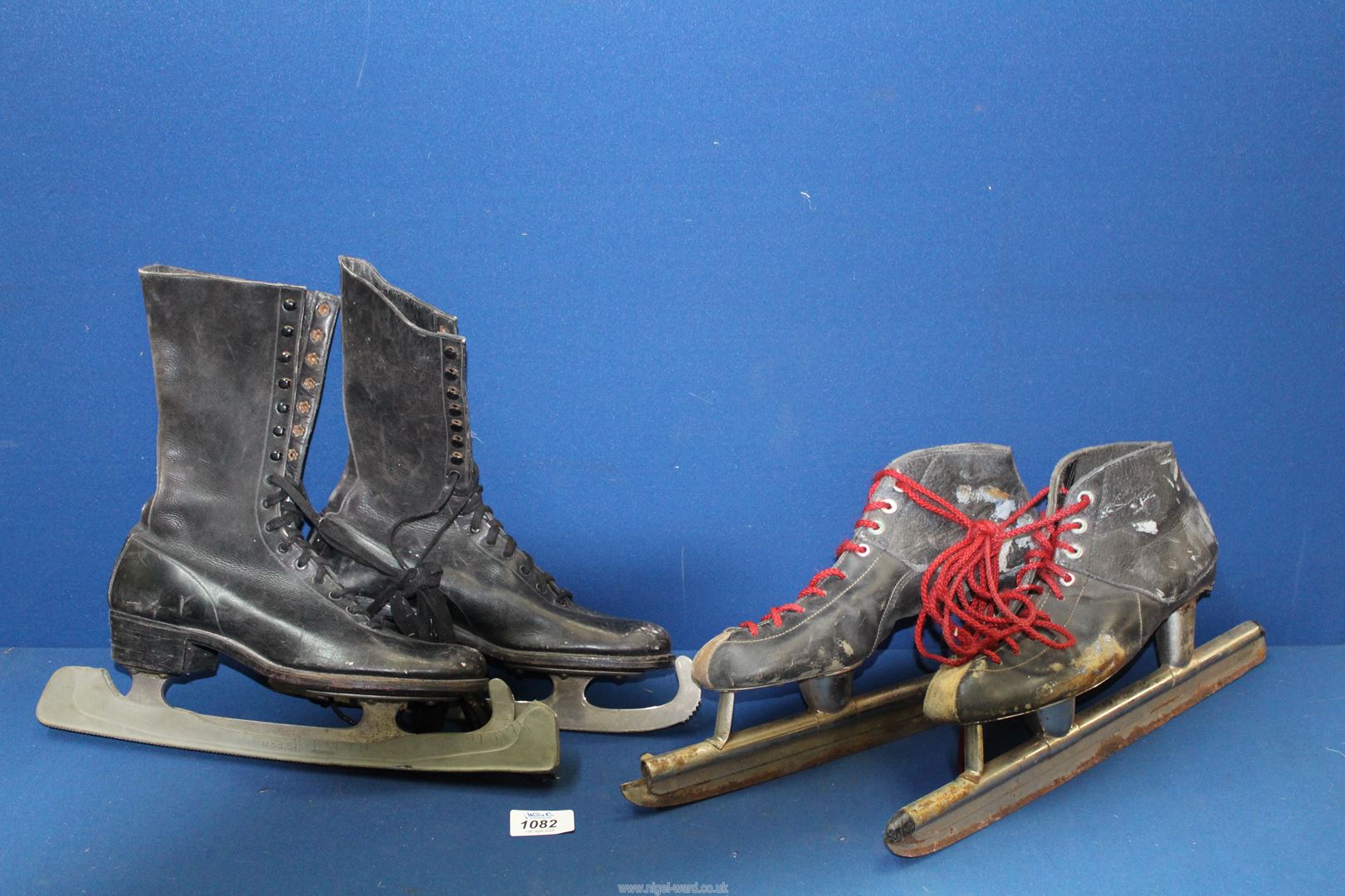 A pair of vintage leather ice skates plus ornate pair of speed ice skates.