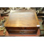 A table top Chest with slope with lower drawer and brass swan drop handle,