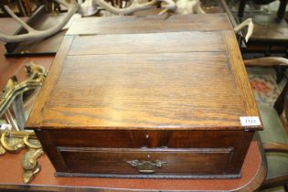 A table top Chest with slope with lower drawer and brass swan drop handle,