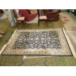 A large Rixos Turkish rug cream stylised flowers on black ground and floral border,