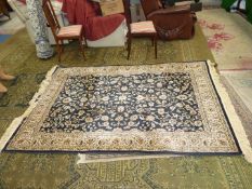 A large Rixos Turkish rug cream stylised flowers on black ground and floral border,