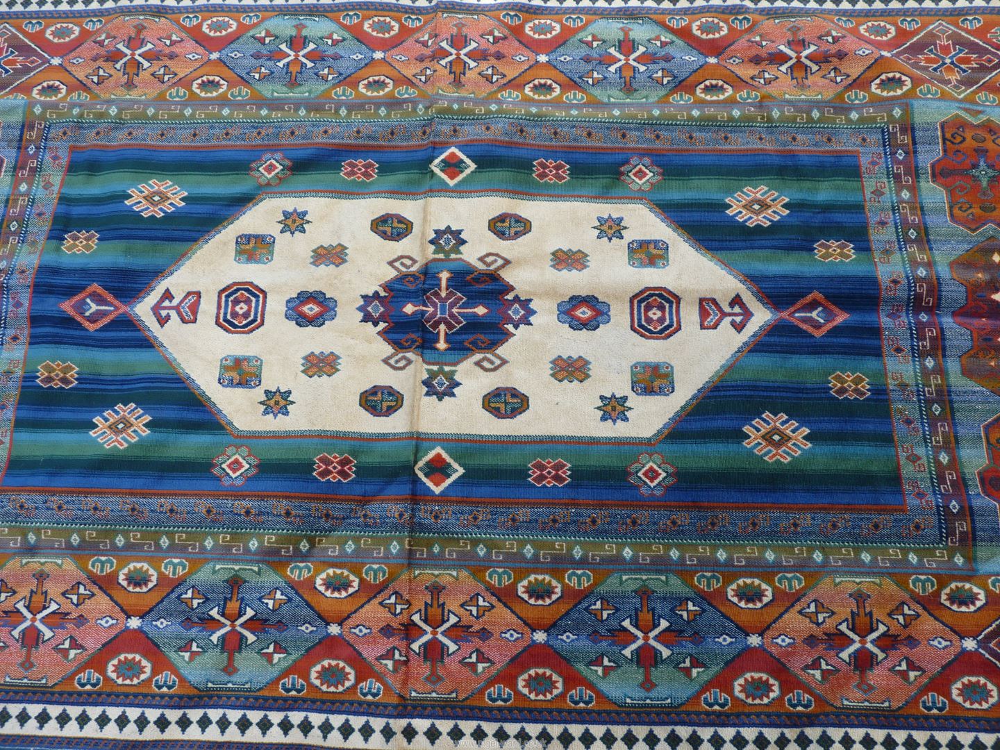 A bordered, patterned and fringed lightweight rug in bright Moorish colours with raised textures, - Image 2 of 3