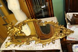 A large old Gesso and giltwood framed wall mirror with slight losses, 37" x 25" approx.