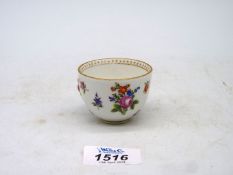 An early Meissen porcelain wine cup having 'in relief' floral decoration with crossed swords mark