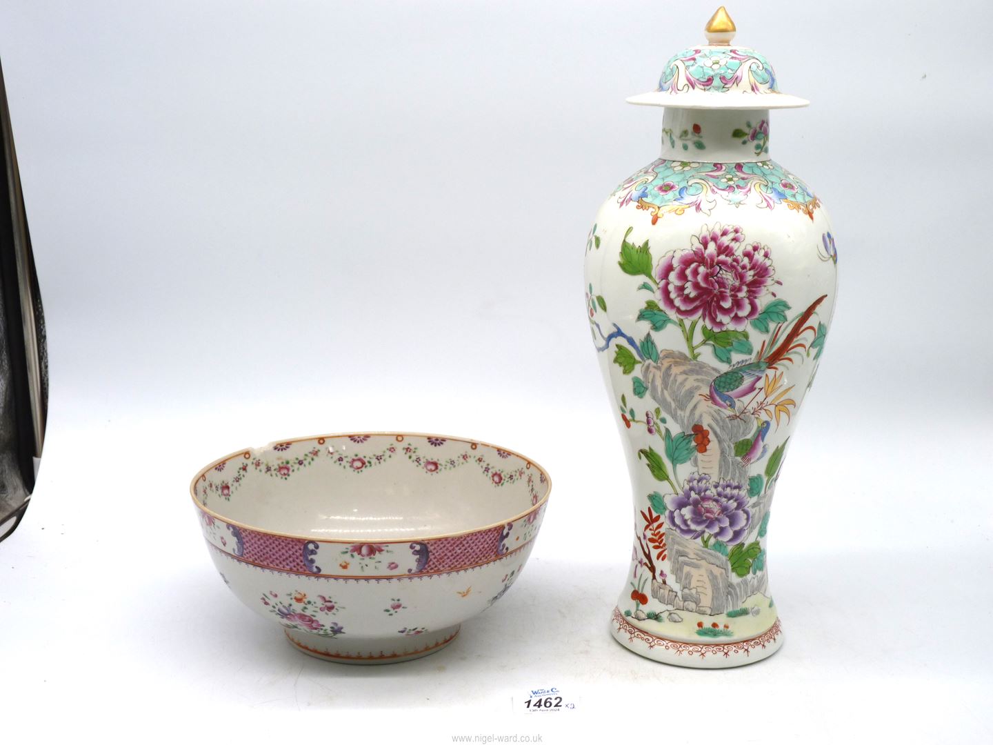 An Oriental lidded vase in colourful floral and bird pattern [mark to base] damage to neck & lid]