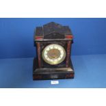 A black slate Mantle clock with dark red detail, Arabic numerals on enamel face,