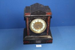 A black slate Mantle clock with dark red detail, Arabic numerals on enamel face,