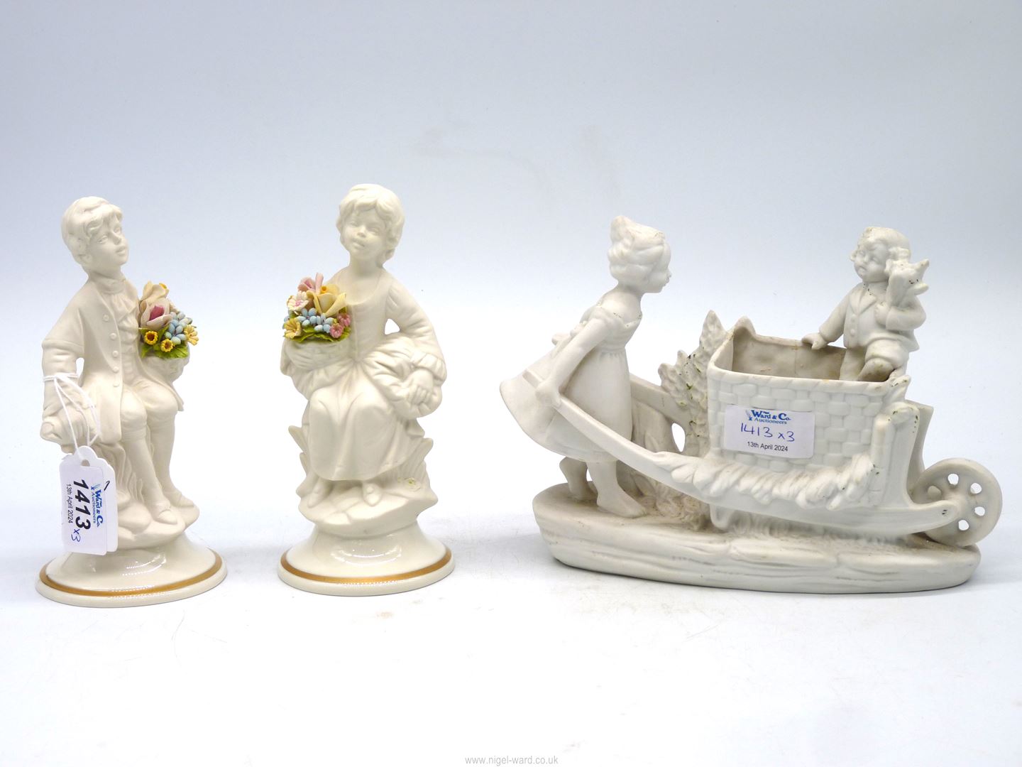 A pair of 20th century Naples Parian ware figures on glazed bases,