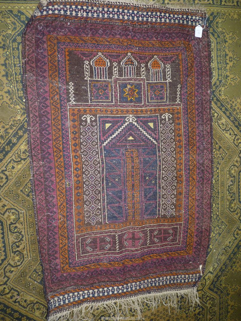 A Prayer rug in earth tones, brown and navy, 60'' x 35'' including fringe, some holes. - Image 3 of 4