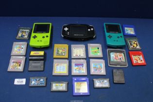 A Nintendo Game Boy Advance console and two Game Boy colour consoles,