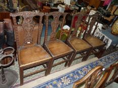 A set of four carved early Oak Dining Chairs having solid seats,